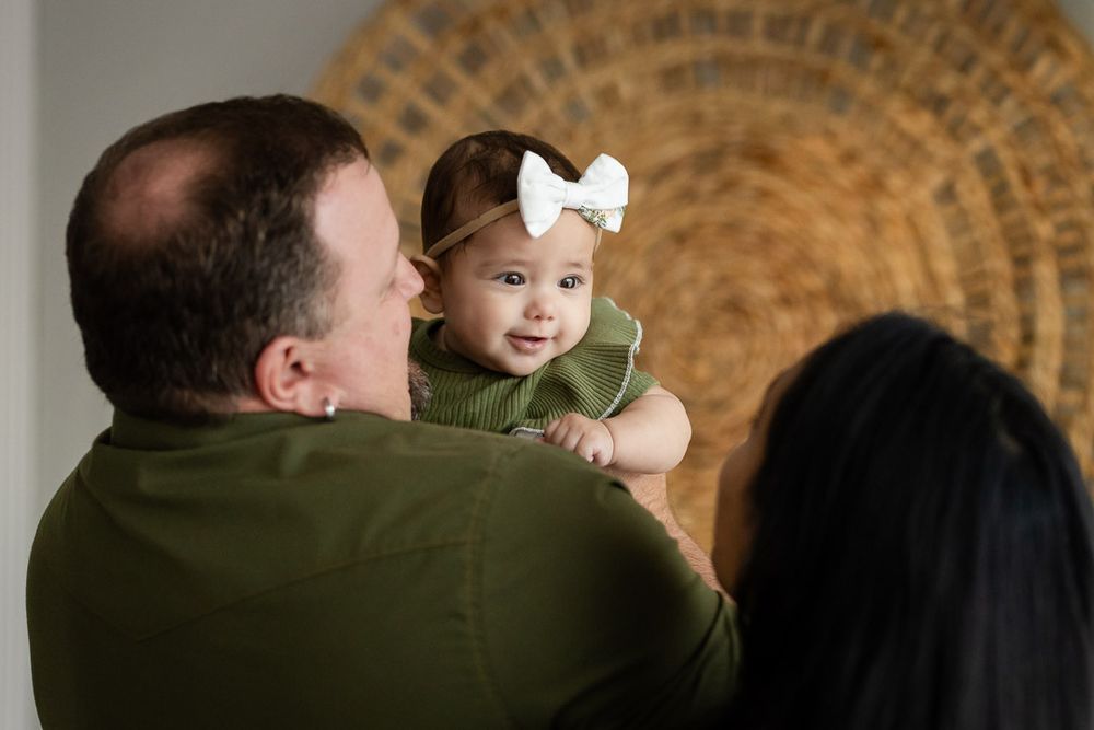 Dad holding his baby girl during a lifestyle studio family session in Mountain Home, Arkansas