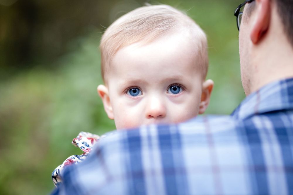 Baby over dad's shoulder during a family session in Mountain Home, Arkansas