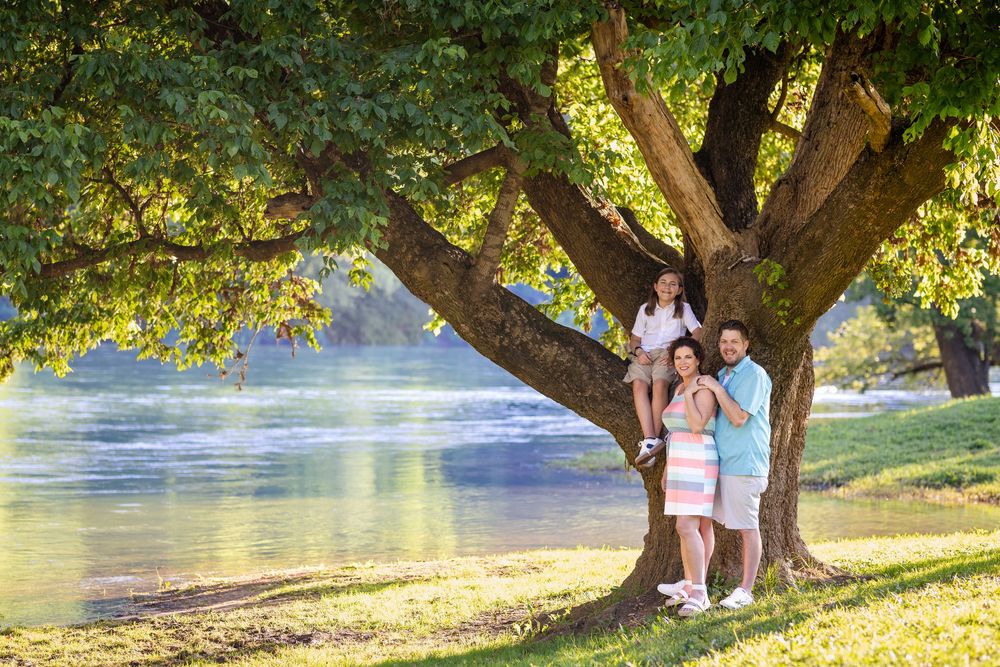 Family beneath a large tree by the Buffalo River in Buffalo City, Arkansas