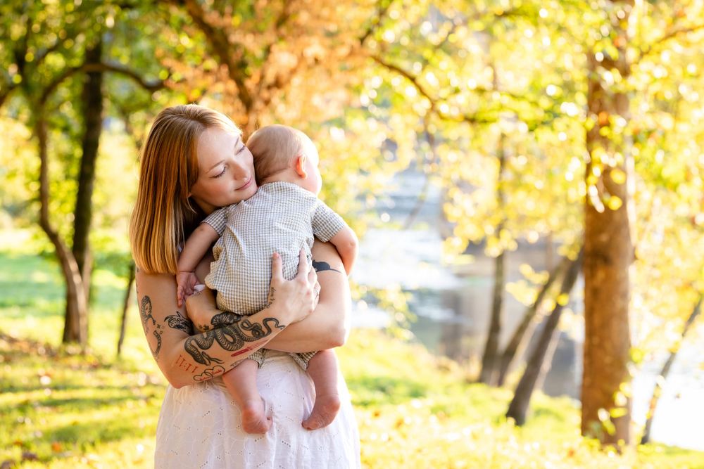 Mother holding her child during a family session on the White River in Cotter, Arkansas