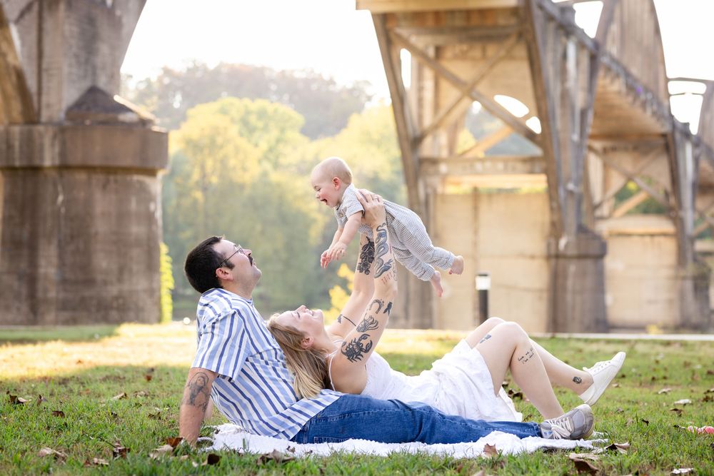 Family with their baby under the old bridge in Cotter, Arkansas