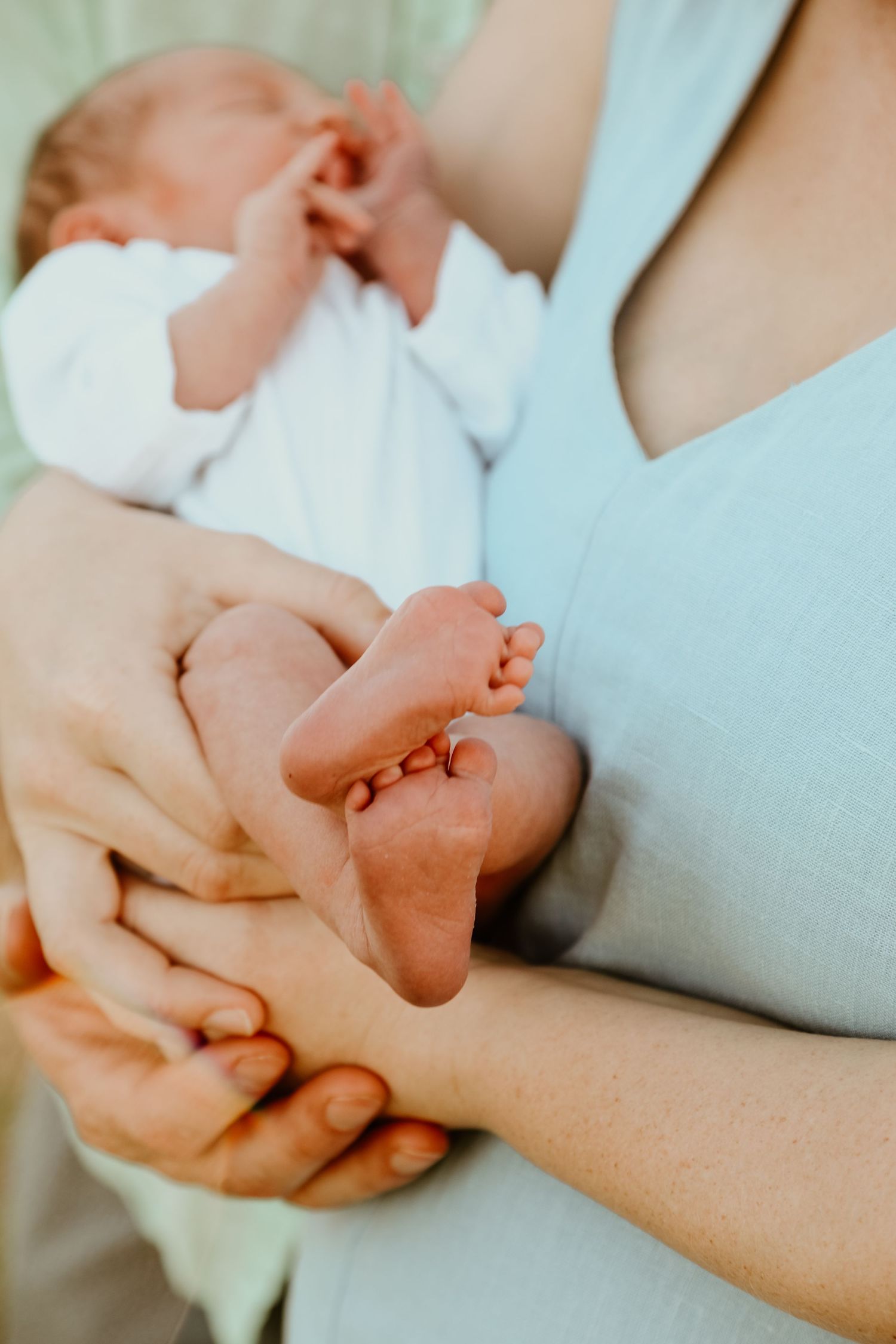 Close-up shot of holding hands showing gentle intimacy and connection.
