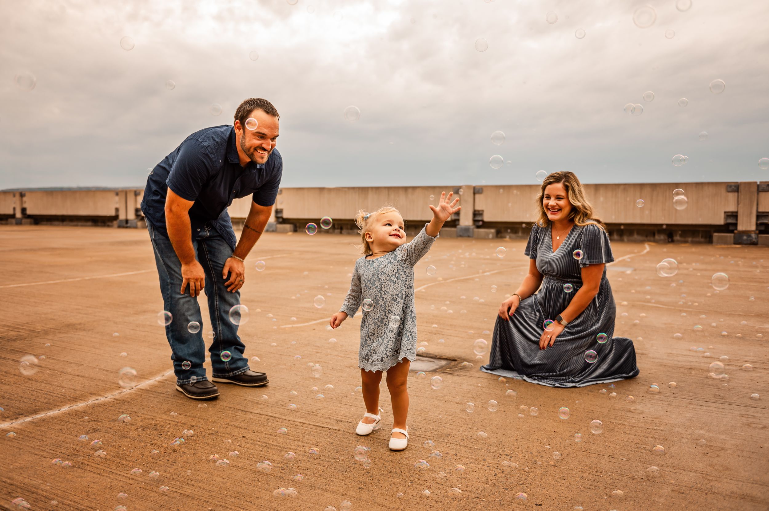Joyful family moment captured on a cloudy day outdoors.