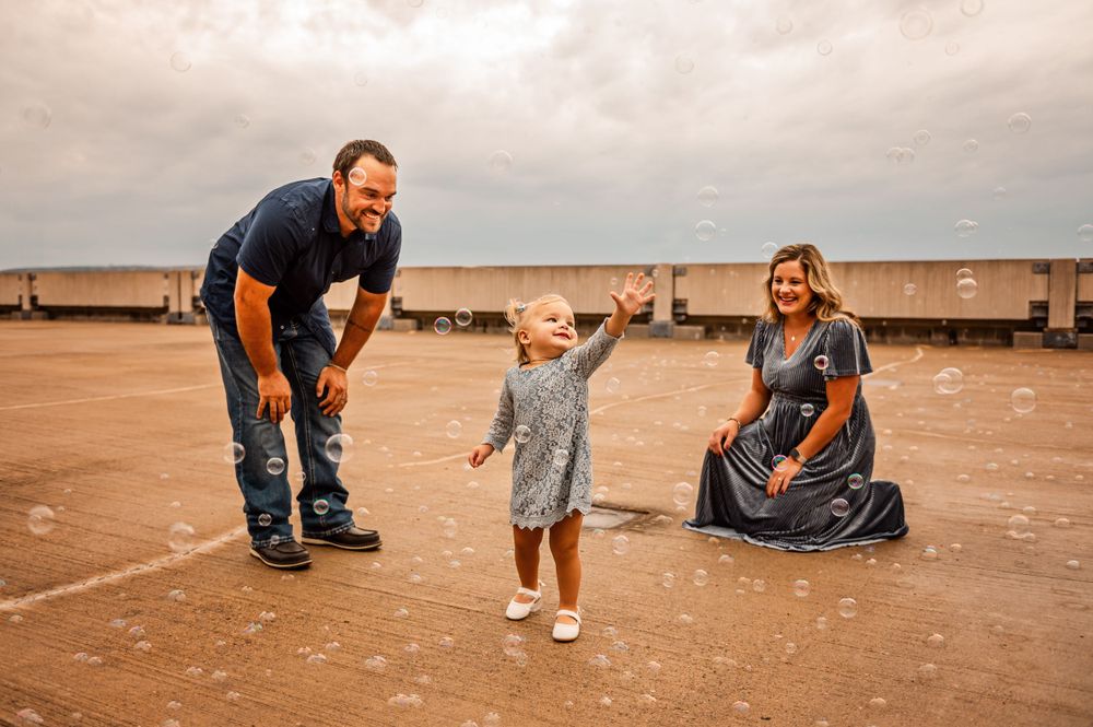 Joyful family moment captured on a cloudy day outdoors.