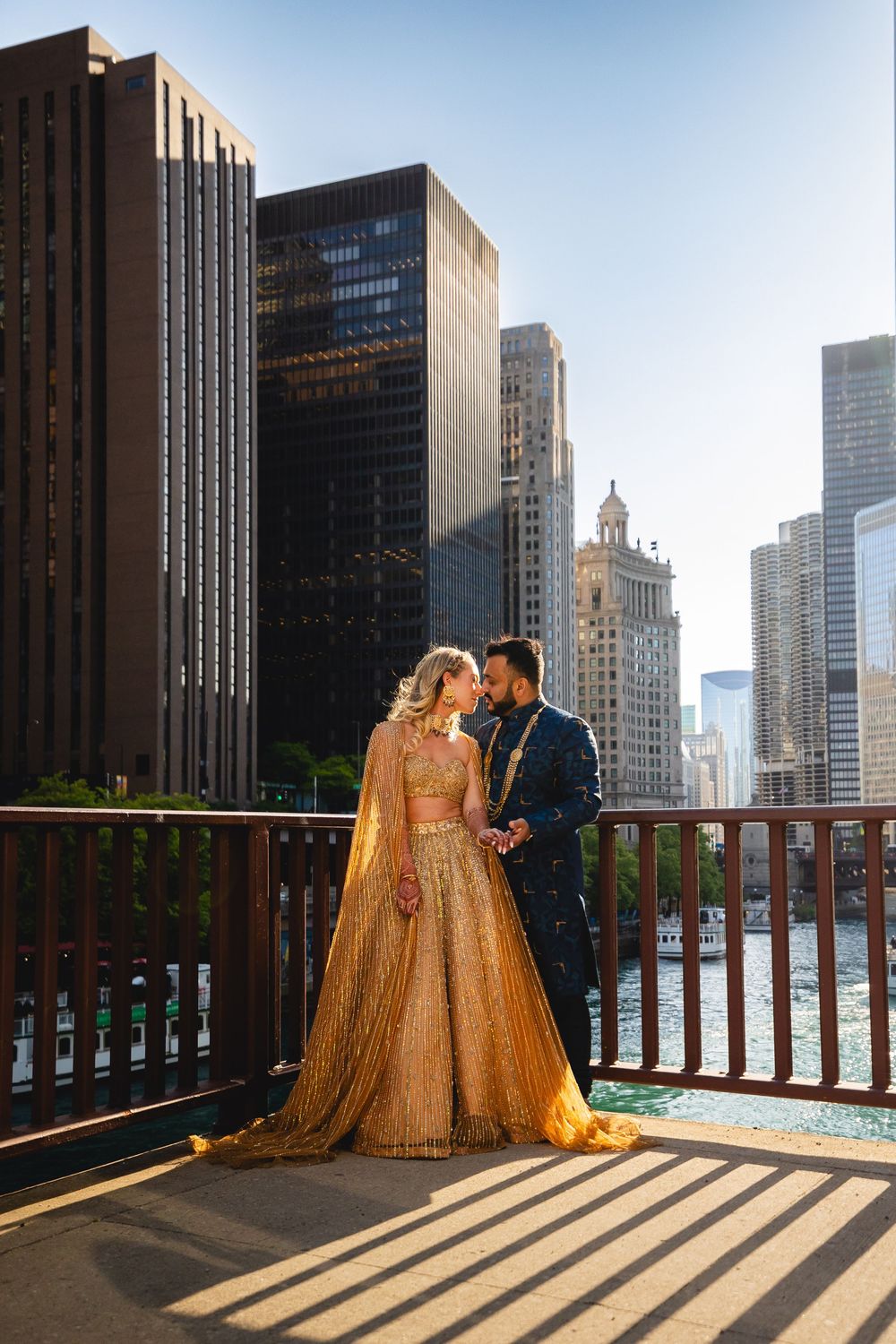 A couple in formal attire share intimate moments on a rooftop terrace with Chicago's iconic skyline in the background.