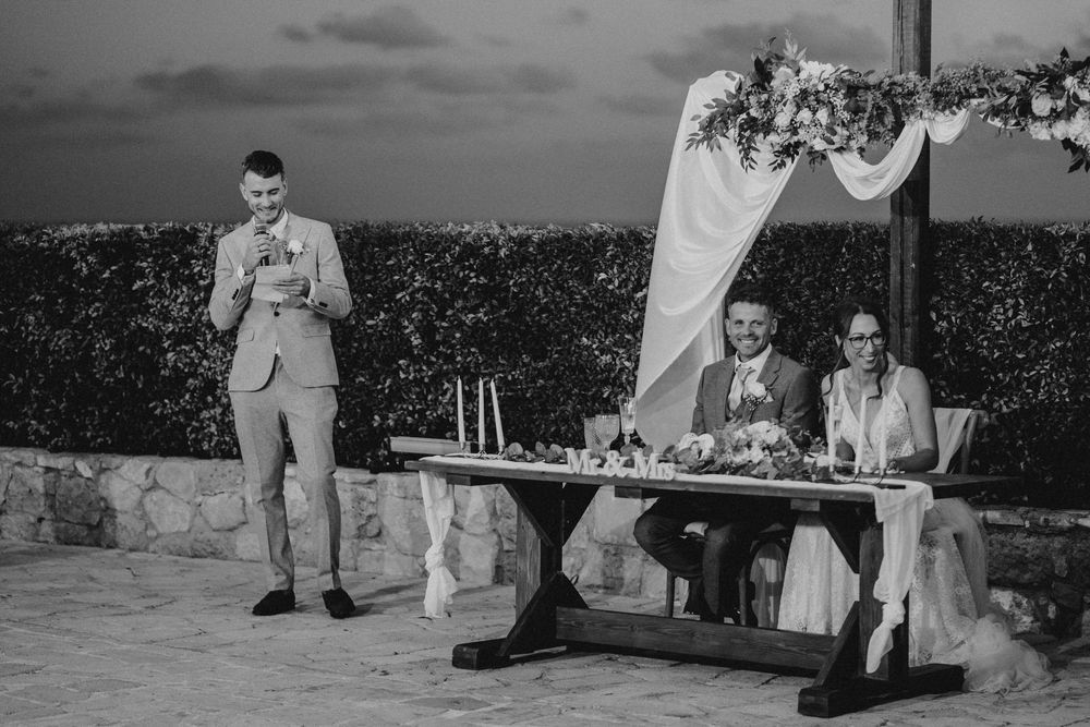 A black and white collage of outdoor wedding photographs showing couples and guests at a garden celebration.