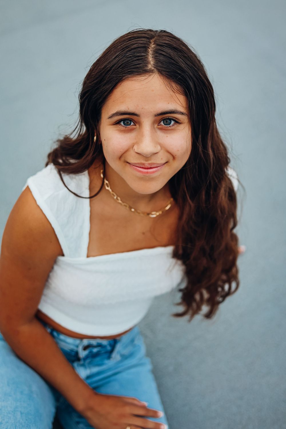 Series of casual portraits against blue background showing joyful expressions.