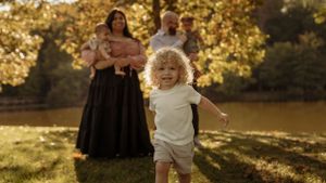 Family enjoying a golden sunset together in a park during an autumn photoshoot.