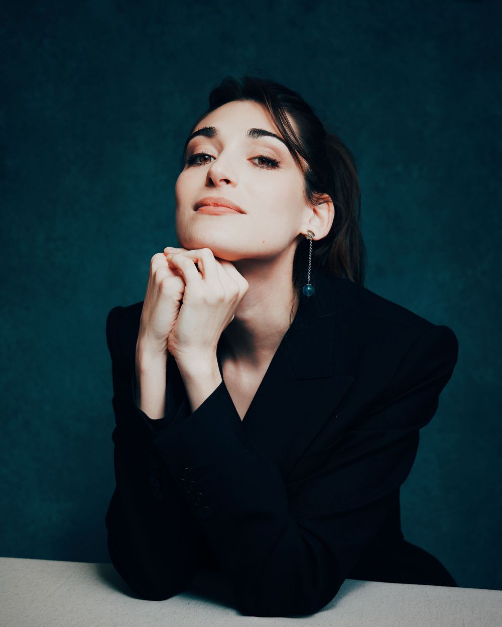 Artistic fashion portrait of the italian actress Pilar Fogliati in dark teal tones showing dramatic poses against moody background.