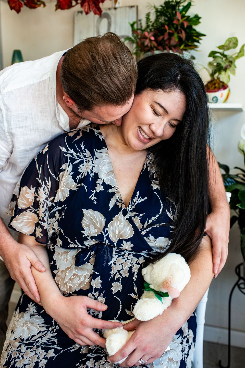 Three sequential photos show someone in a navy floral dress holding a small white kitten against their chest.