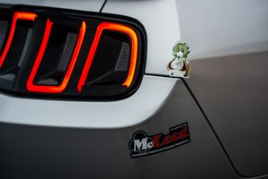 Close-up detail shots of a red illuminated LED taillight design on a modern vehicle.