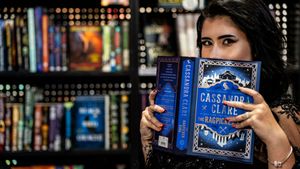 A collection of fantasy books displayed in a library setting with dramatic lighting and bokeh effects.