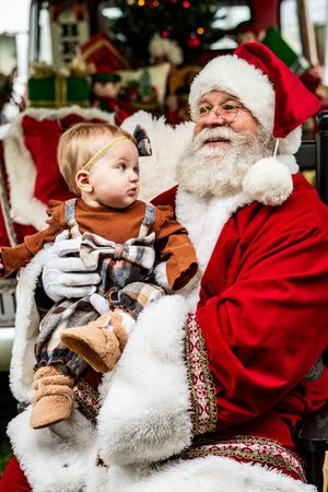 A series of festive holiday photos showing interactions with Santa Claus in his traditional red suit and white beard.