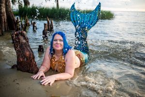 A sequence of splashing water photos shows someone falling into a lake while wearing a blue dress.