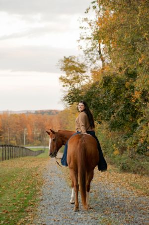 A trail ride through autumn scenery with colorful fall foliage along a gravel path.