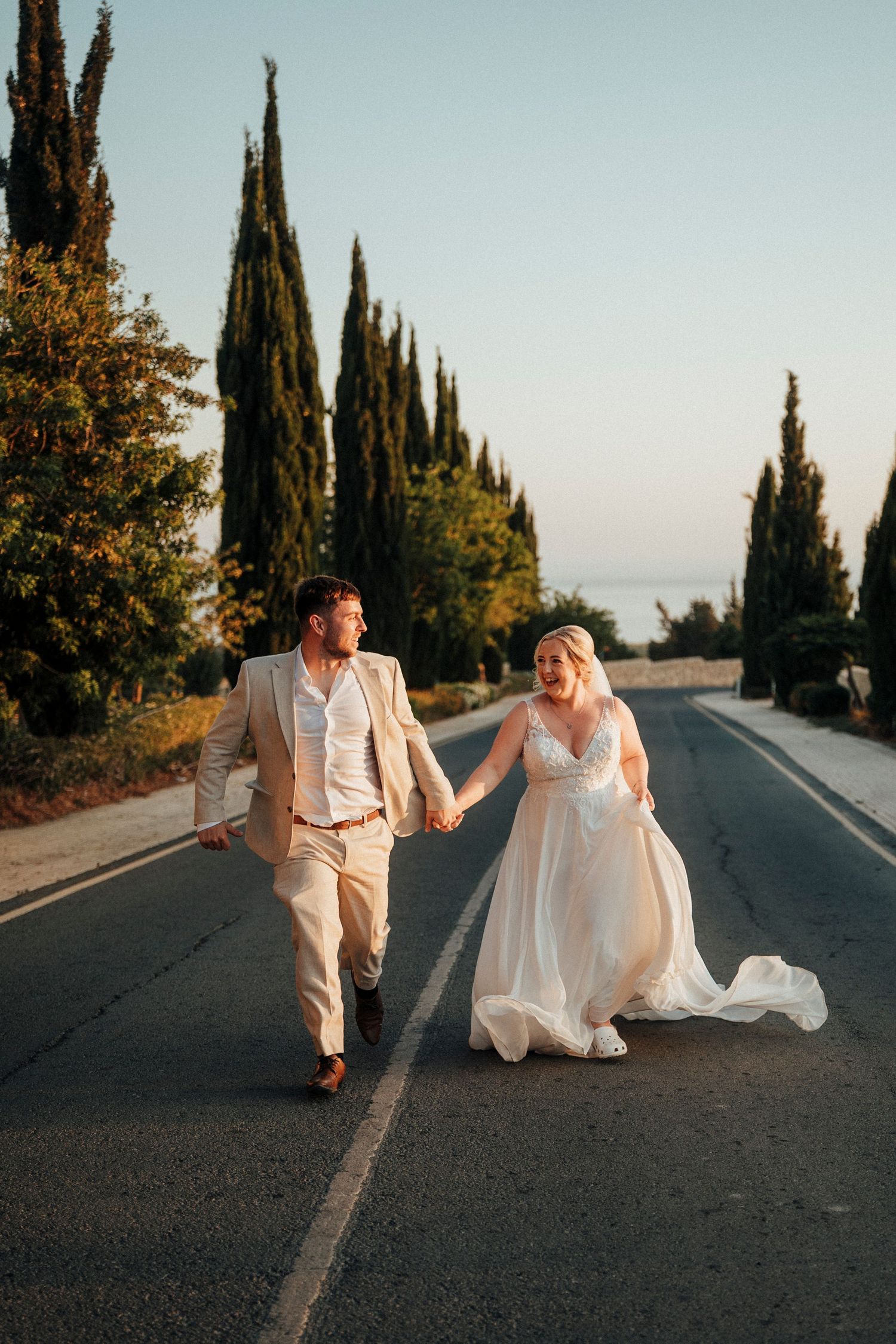A joyful moment shared during an outdoor wedding reception in a garden setting.