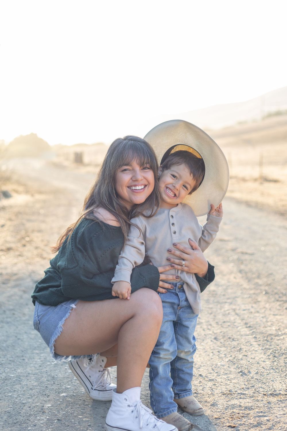 Heartwarming scene of a family, such as parents and children, smiling and laughing together, captured in a natural light setting with a clea