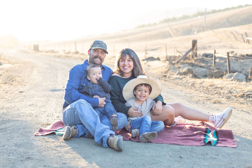 Heartwarming scene of a family, such as parents and children, smiling and laughing together, captured in a natural light setting with a clea