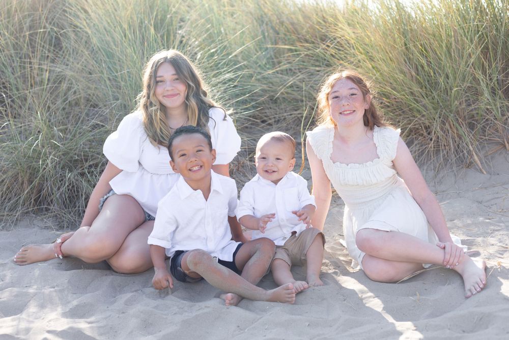 Heartwarming scene of a family, such as parents and children, smiling and laughing together, captured in a natural light setting with a clea
