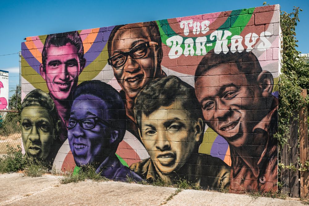 Vibrant colorful mural art in Memphis, TN decorates a brick wall featuring The Bar-Kays.
