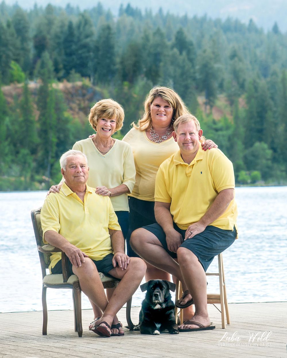 Portrait of family of four wearing yellow outfits with Spokane river view by Post Falls photographer Luba Wold