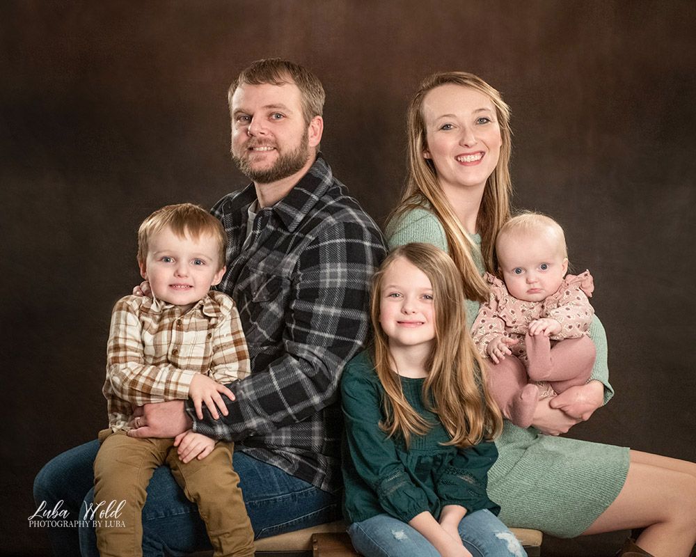 studio family of five portrait teal and brown color by photographer Luba Wold in Post Falls