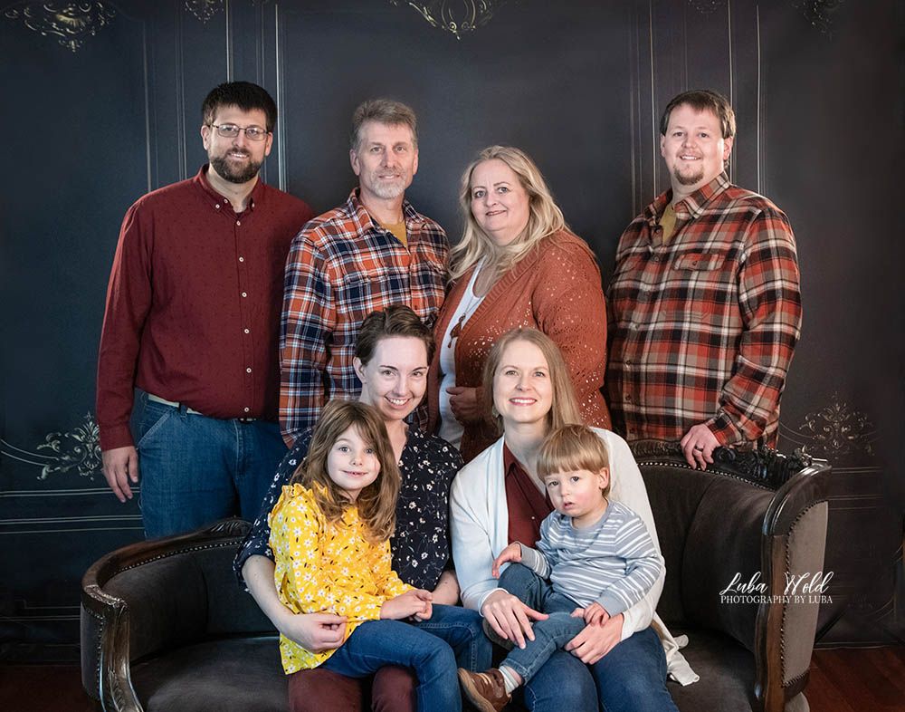 studio family portrait of eight in burgundy, yellow and blue colors by Post Falls photographer Luba Wold
