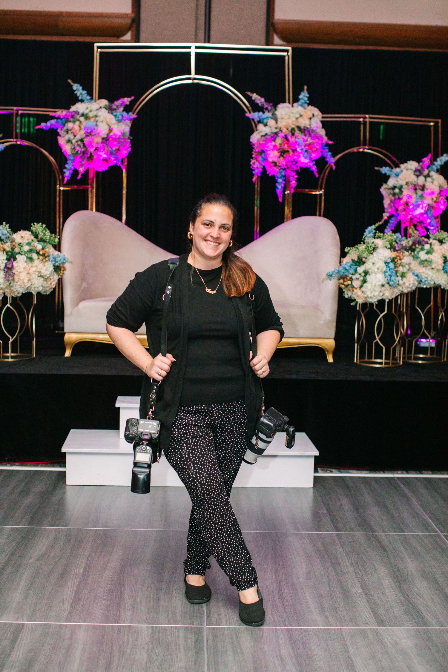 Dance studio interior with colorful floral arrangements and gold accents featuring casual portrait poses.