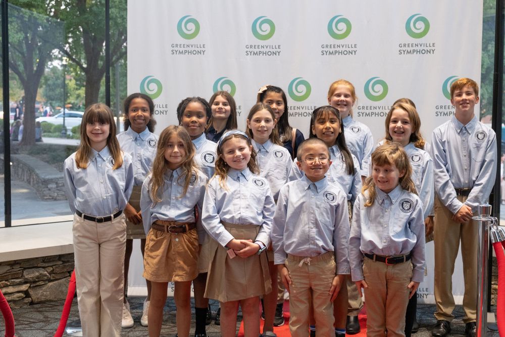 Group of young students pose together at a Greenville Symphony event.