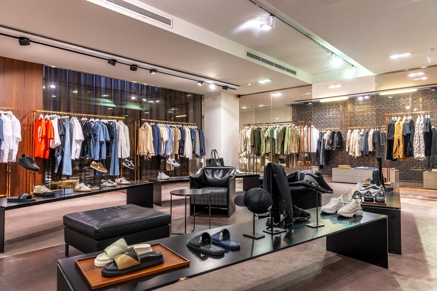 Luxury clothing boutique with colorful garments on racks, designer shoes, and elegant interior lighting.