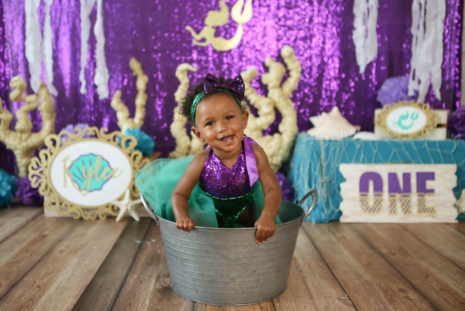 Little mermaid is one years old.  Custom background made by the photographer for cake smash session.