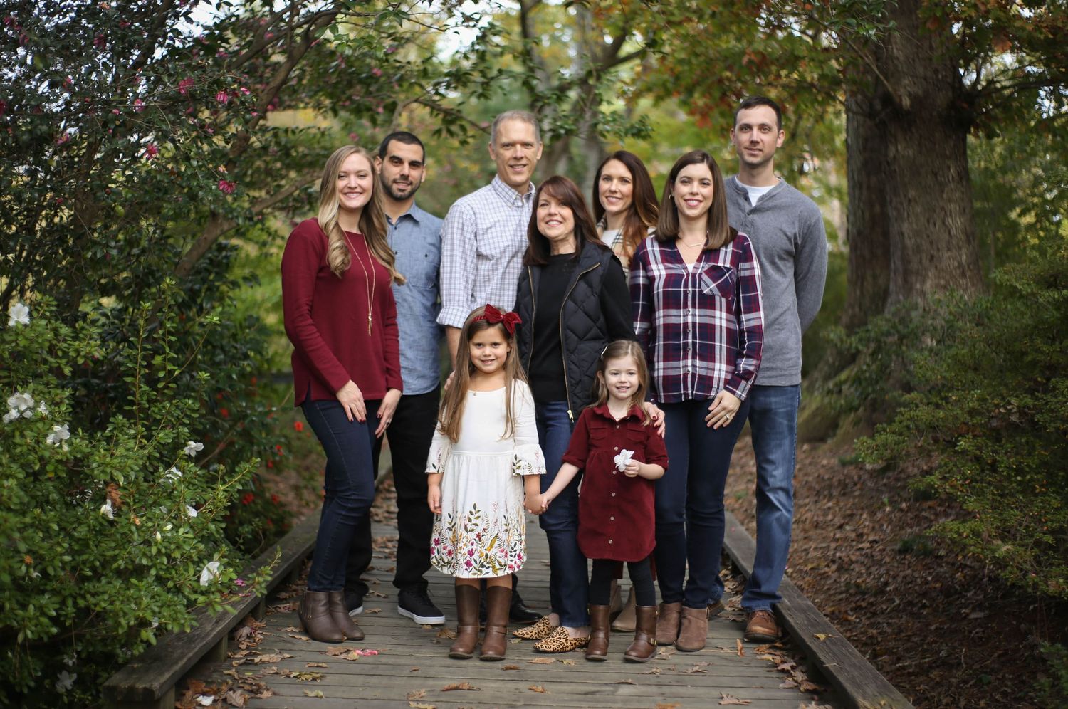 Three generations captured in family photo on wood walkway at Glencarin Gardens in Rock Hills, SC.