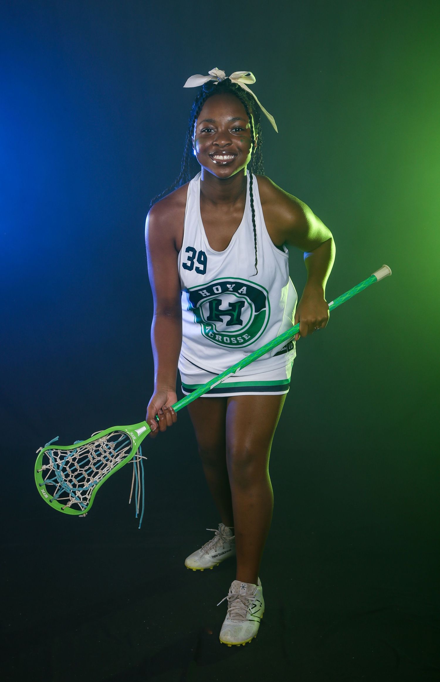 Dramatic lacrosse sports portrait, featuring colored gel lighting and smoke effects for bold, high-impact look. Girls middle school team