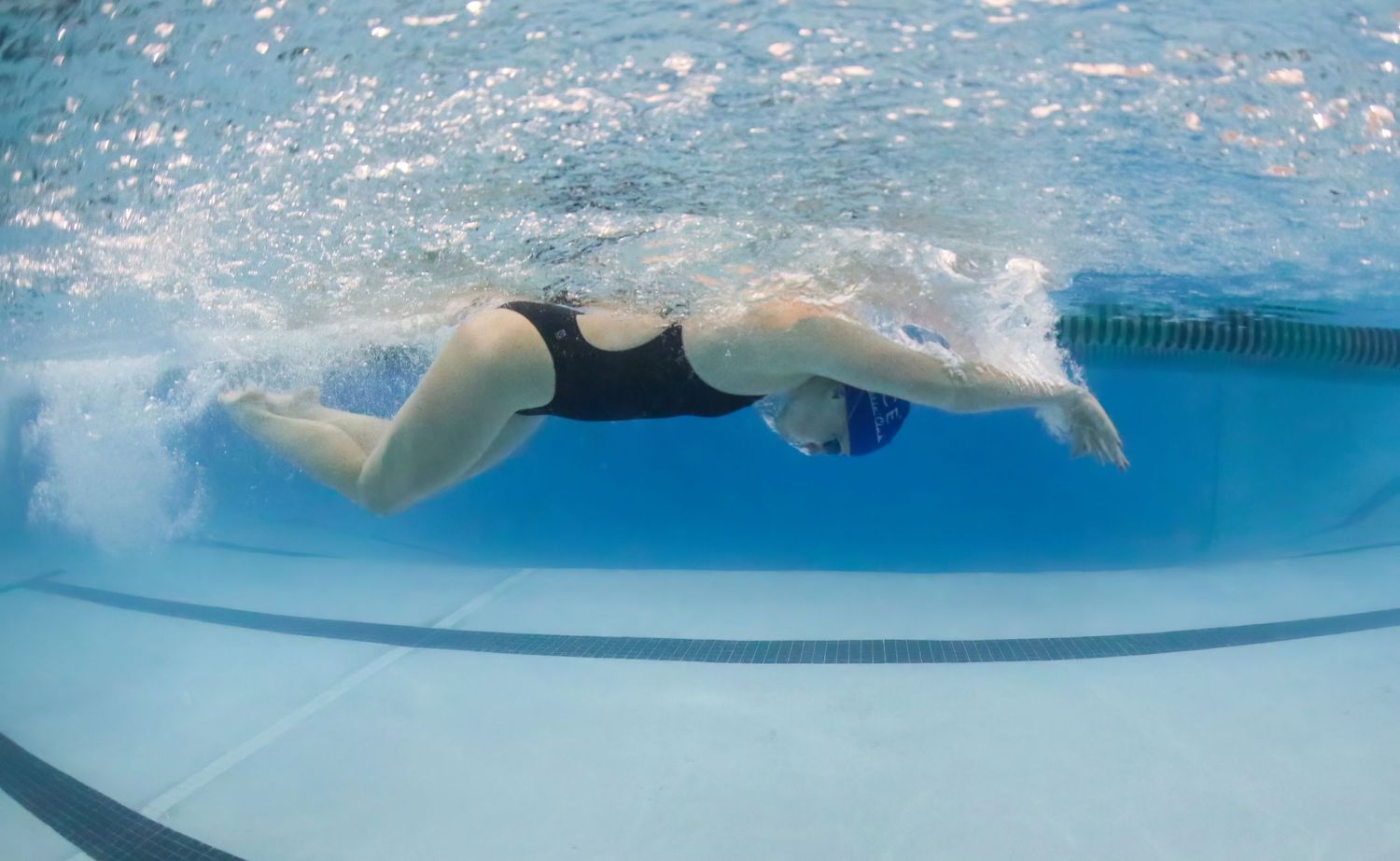 Underwater photographer captures high schooler swimming butterfly.  Used canon and ikelite underwater housing.