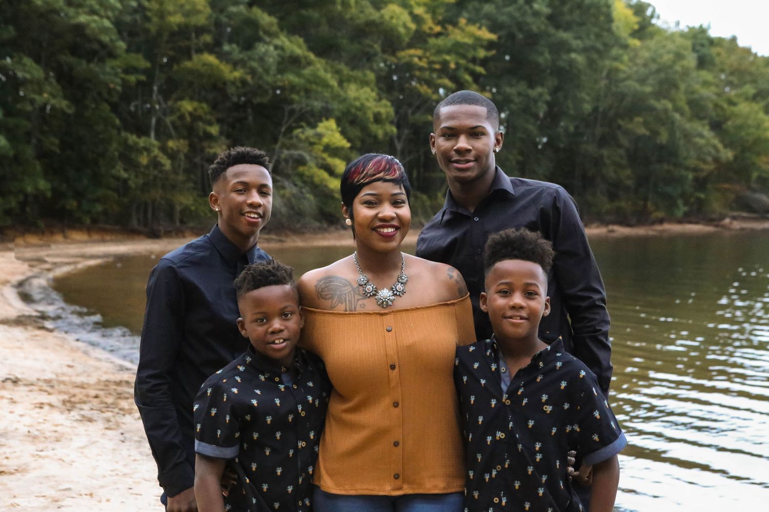 Family of boys pose with mom on the beach at Lake Norman.