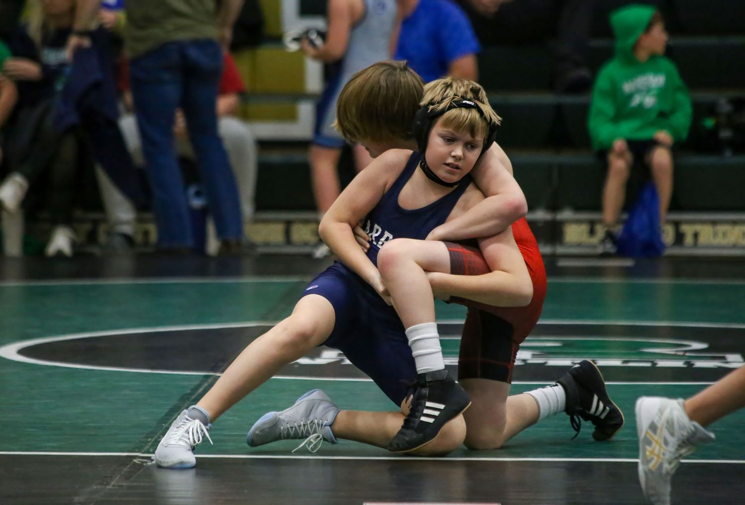 Youth sports photographer capturing junior wrestlers during a tournament.