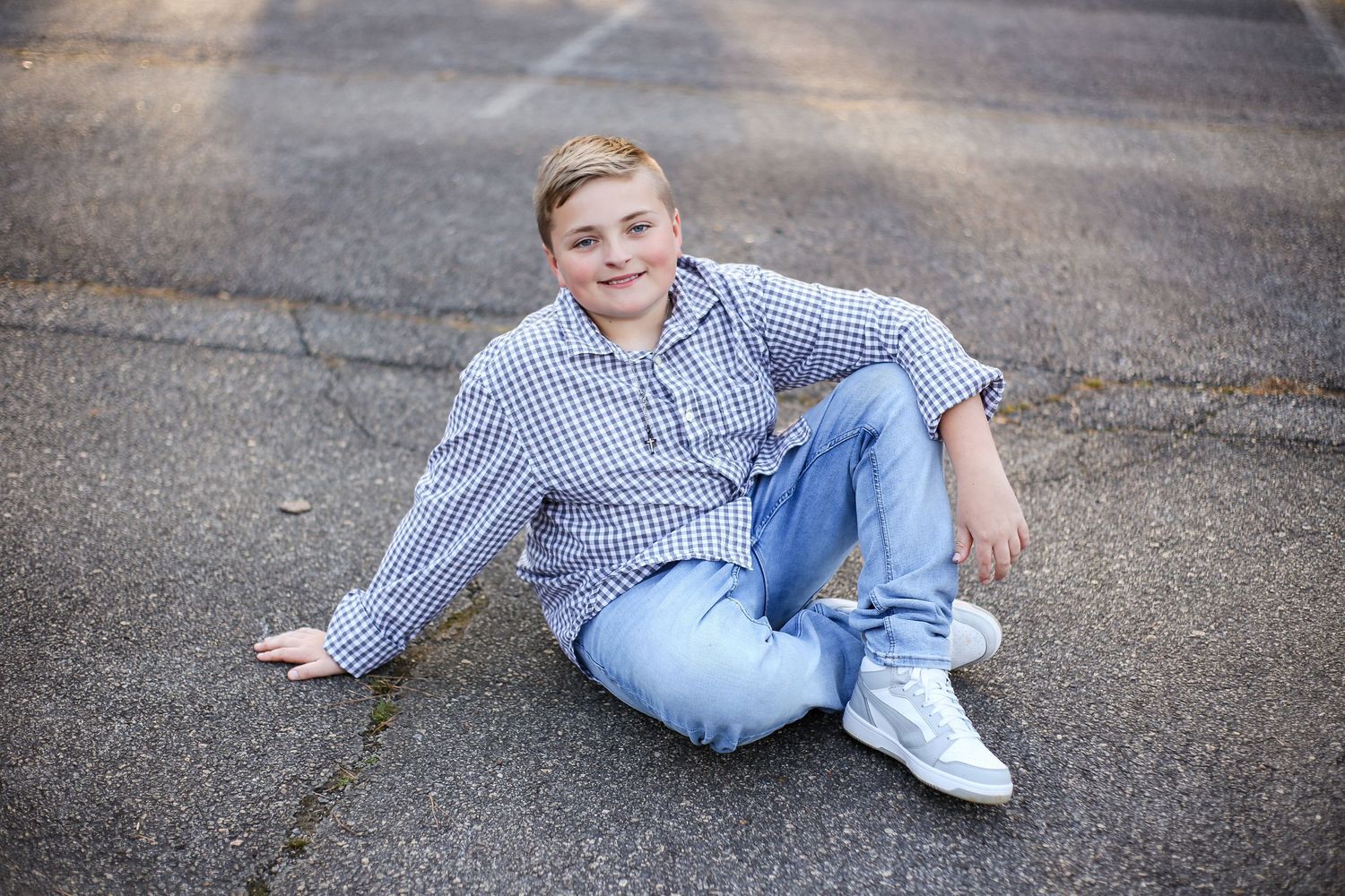 Fifth grade boy casually poses on the blacktop during yearbook dedication session.