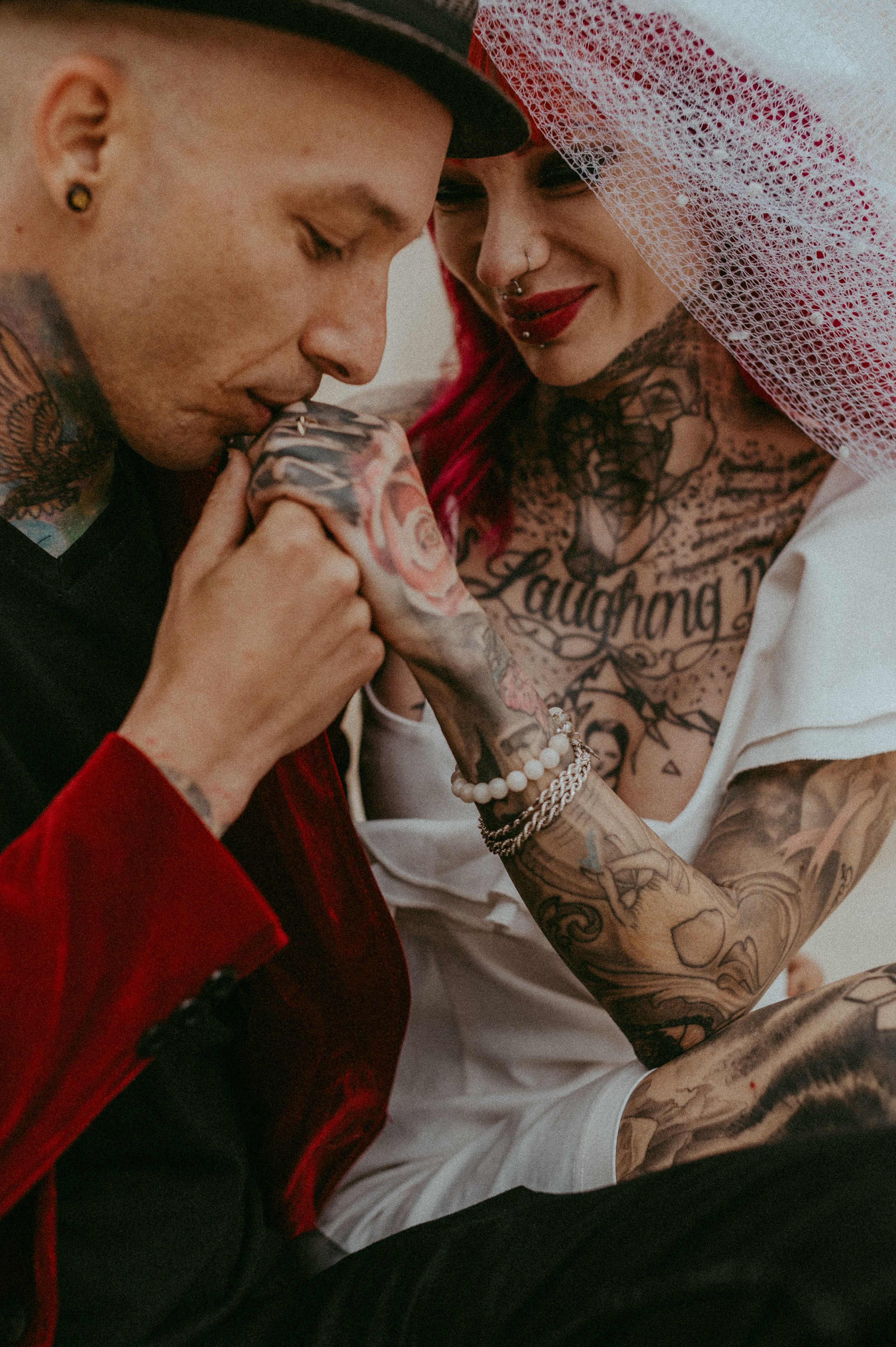 Romantic couple in dark moody lighting share intimate moments in a series of close-up photos.