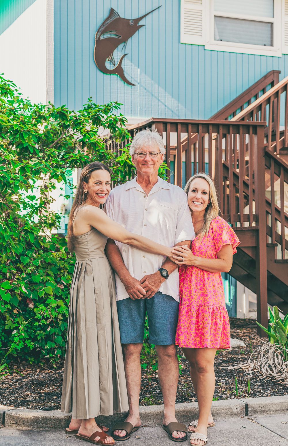 Two daughters hugging their father in Rockport, Texas