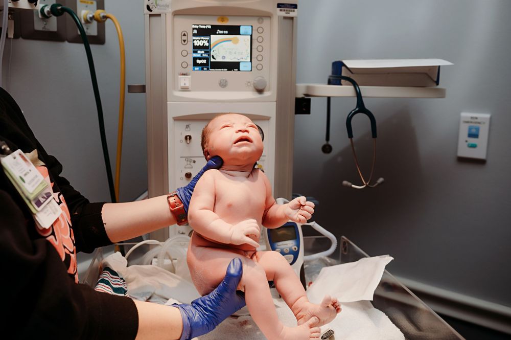 Newborn getting weighed.