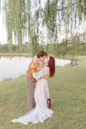 engagement couple with flowers under a weeping willow tree in Markham Virginia