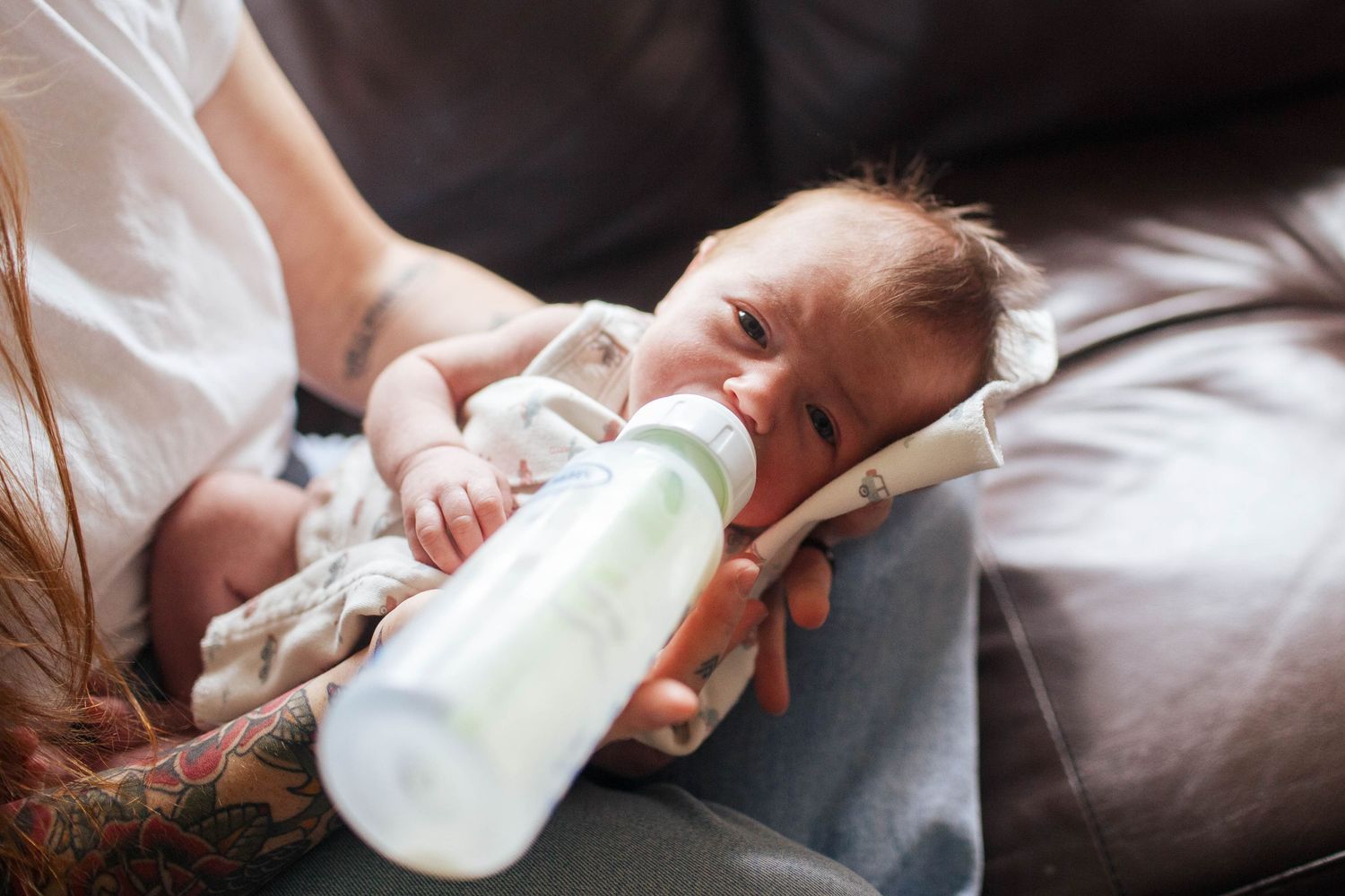 Best Everett newborn and baby photographer: A newborn baby on the bed at an in-home lifestyle newborn session in Mukilteo