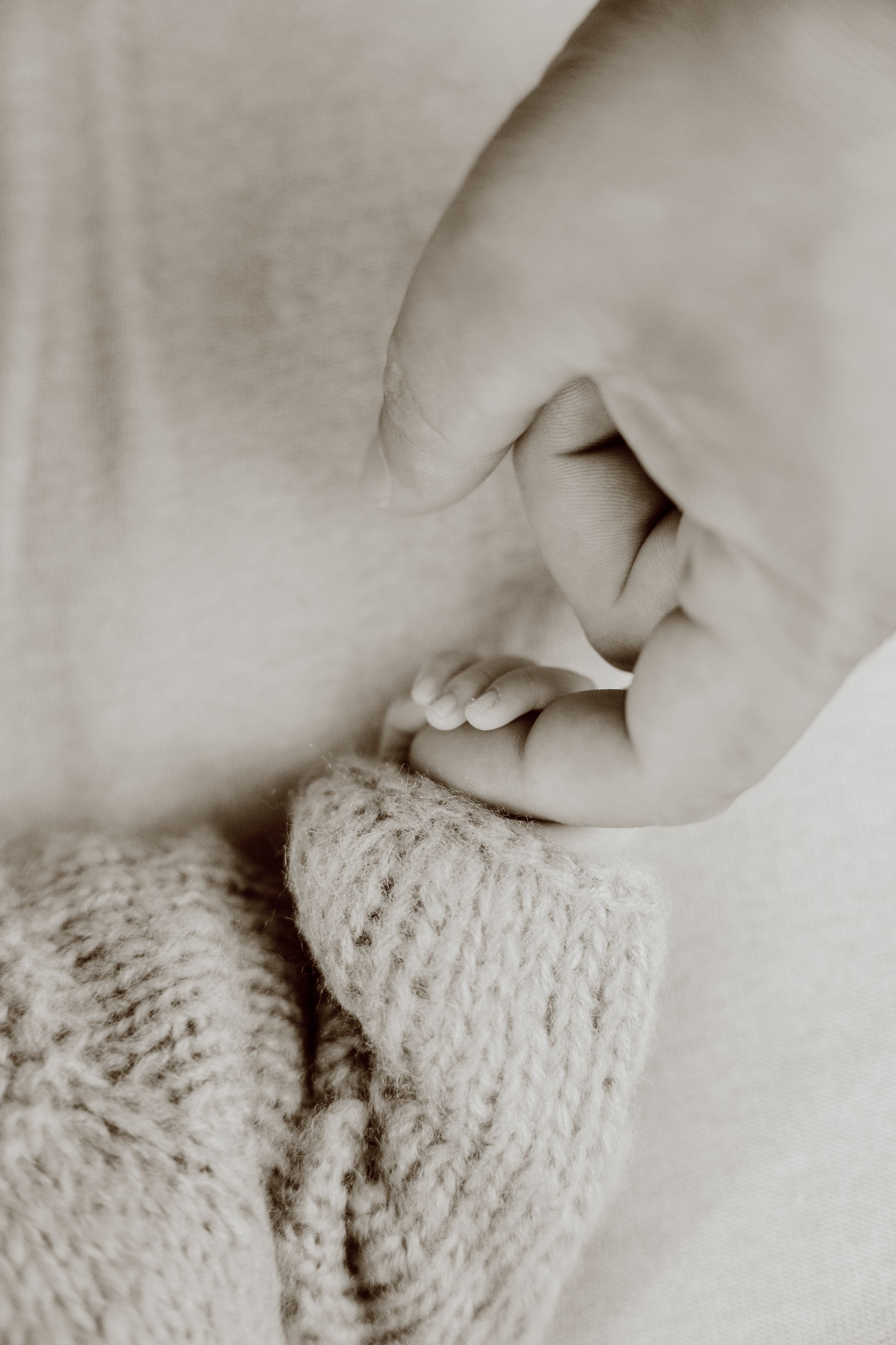 baby holding fathers finger