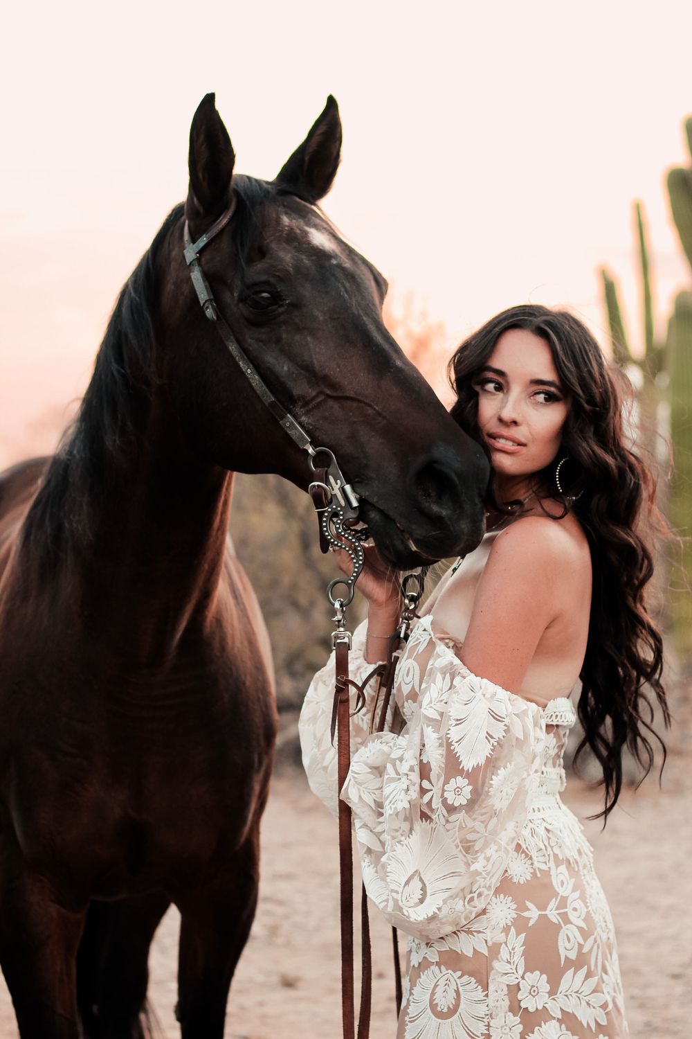 Woman and horse pose for a solo portrait session.