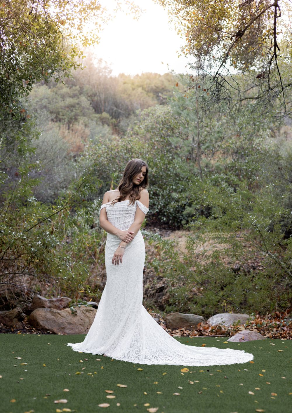 Bridal photo amidst a green forest and grassy field.