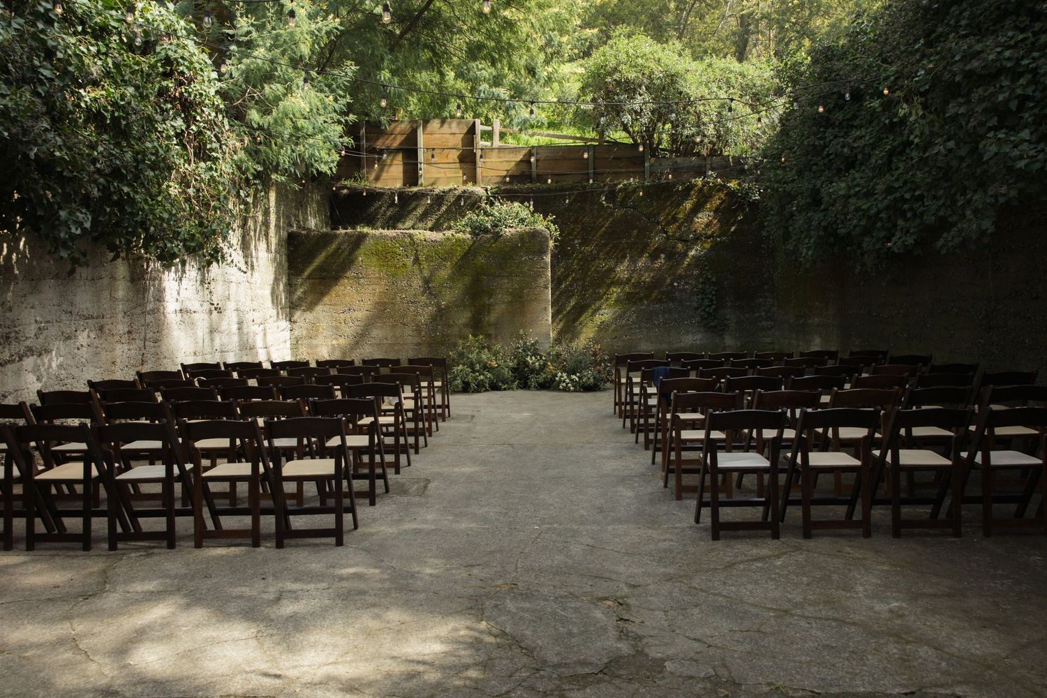 Minimalist nature-inspired wedding ceremony setup inside the barrel room at Sand Rock Farm in Aptos, California