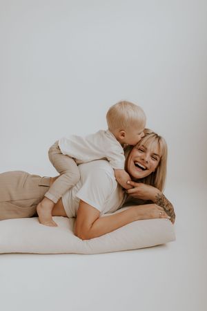 Intimate lifestyle photography session showing joyful moments on white background.