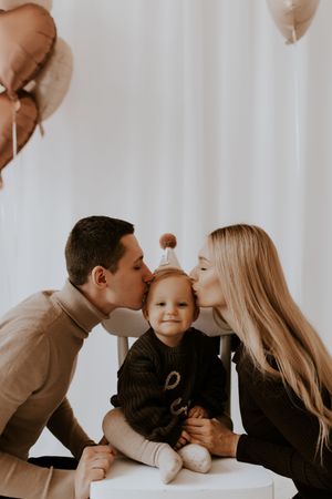 Sweet family portrait series showing loving kisses and embraces against a white backdrop.