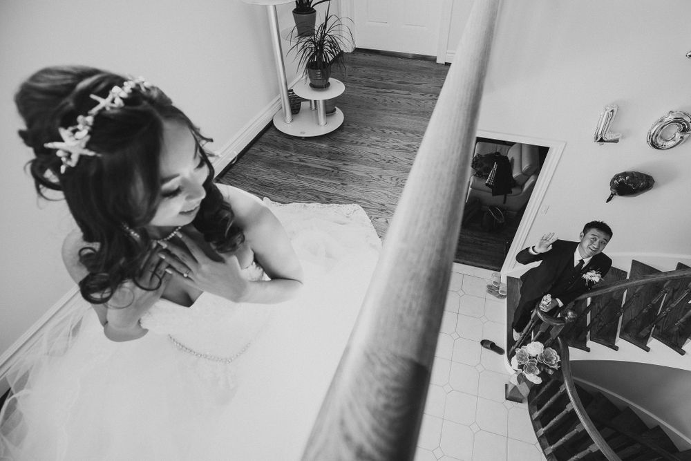 Black and white overhead shot on a staircase showing wedding preparation.