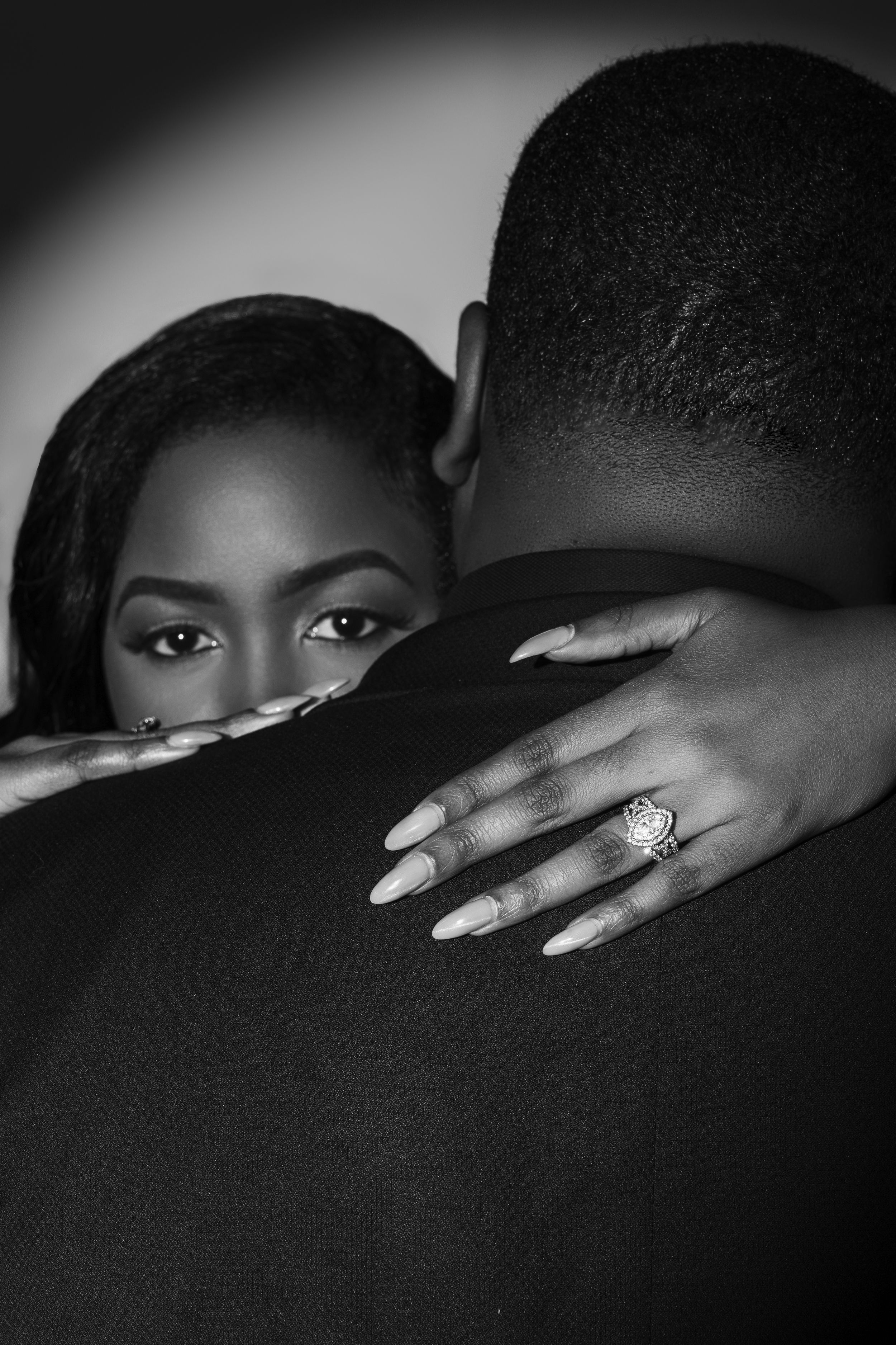 Black and white artistic photo series showing hands with long nails against dark background in dramatic lighting.